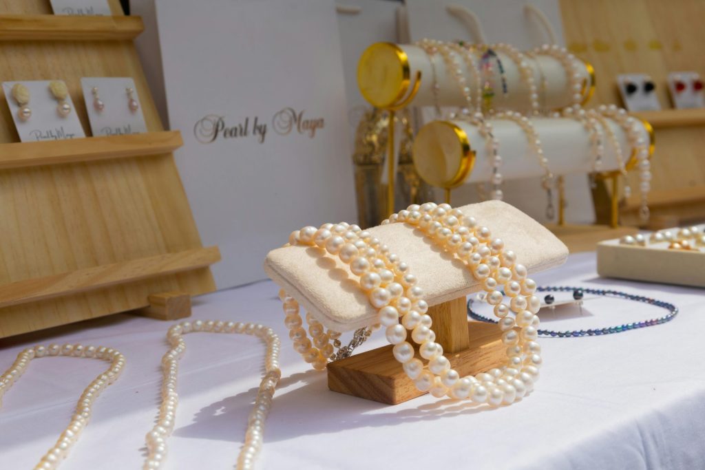 Elegant display of pearl necklaces in a luxury jewelry store setting, showcasing elegance and wealth.