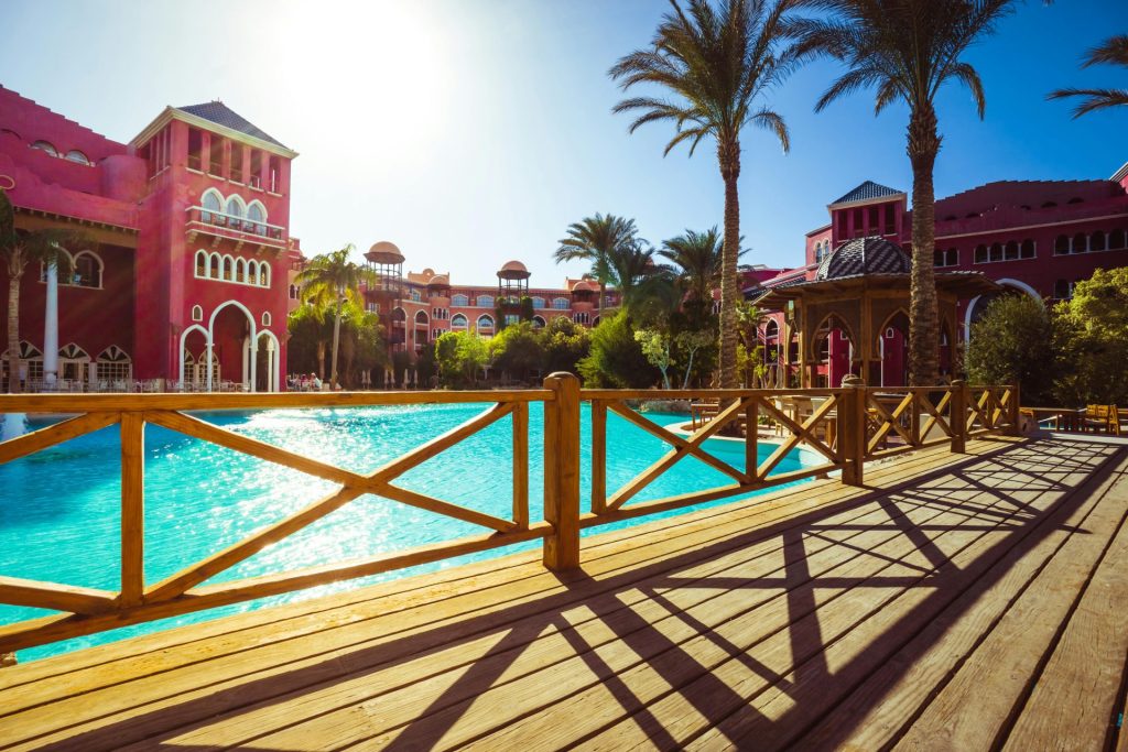 Stunning tropical resort with luxurious poolside, palm trees, and vibrant architecture for ultimate relaxation.