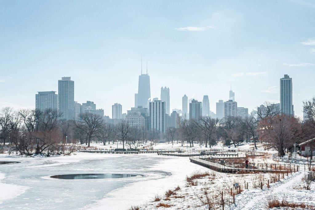 Snow-covered landscape with Chicago skyline in winter, captured from Lincoln Park in Illinois.