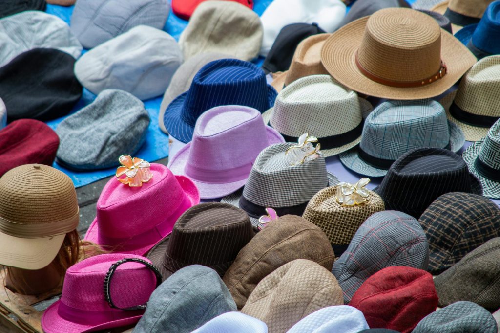 Vibrant display of various hats at a street market in Belo Horizonte, Brazil.