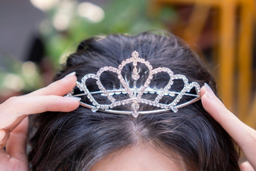 Close-up of a woman wearing a sparkling tiara outdoors in Ho Chi Minh City.