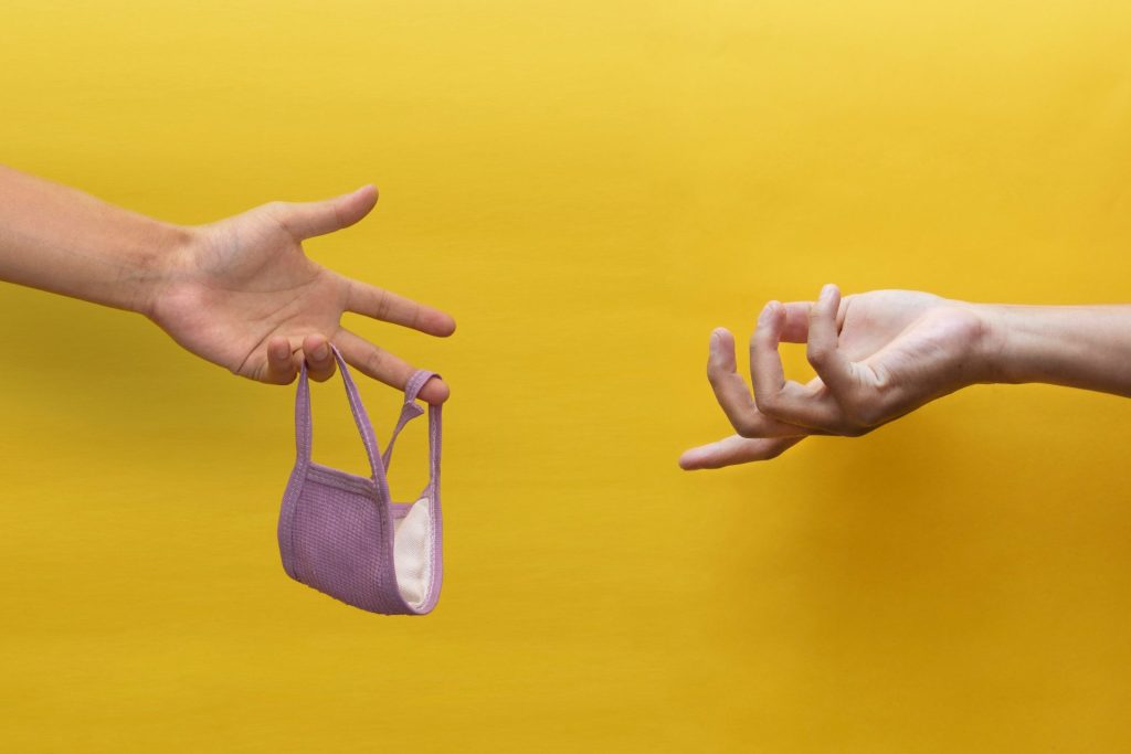 person holding gray and black tote bag