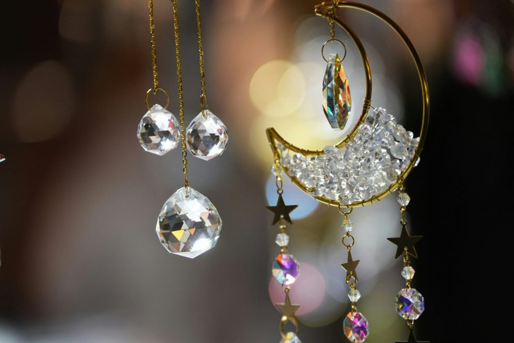 A close up of a wind chime with crystals